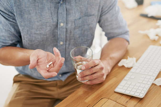 Man Taking Pain Relief