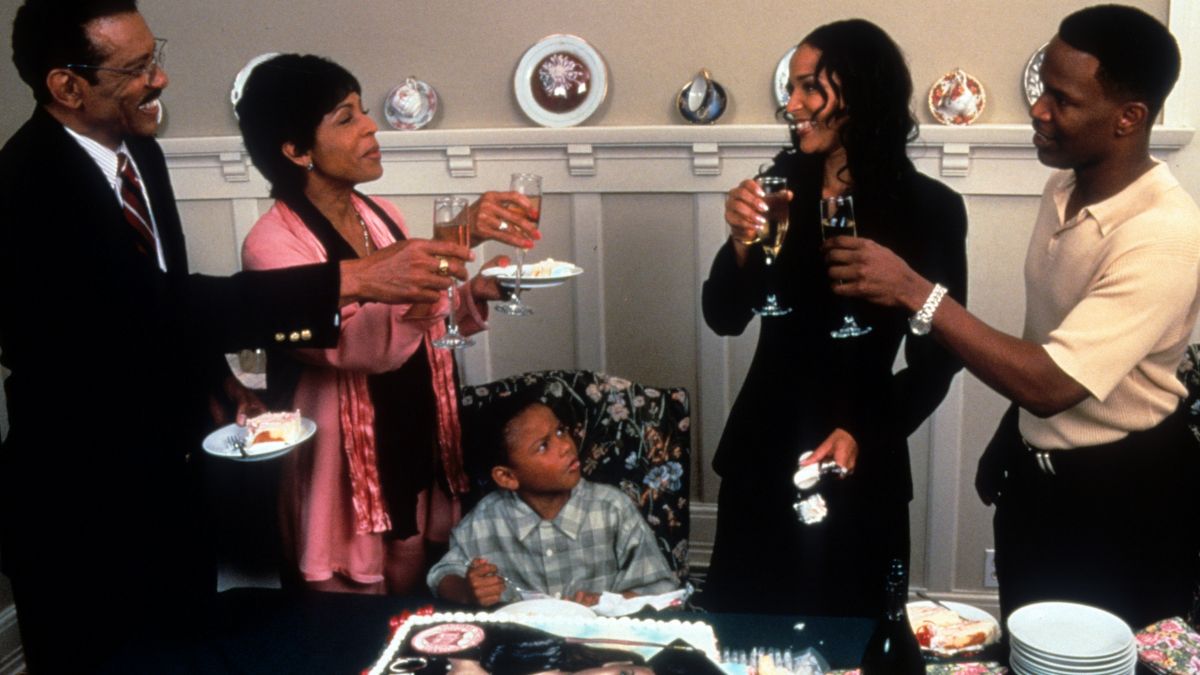 LisaRaye toasts with her family in a scene from the film 'The Players Club', 1998. (Photo by New Line/Getty Images)