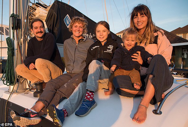 Nikki Henderson's (second left) flight to the US to help Greta Thunberg (centre) sail to Portugal has produced the same amount of carbon emissions the voyage hoped to save. Miss Thunberg can be seen with Australian couple Riley Whitelum (left) and Elayna Carausu (right), and Ms Henderson (second left) on board La Vagabonde