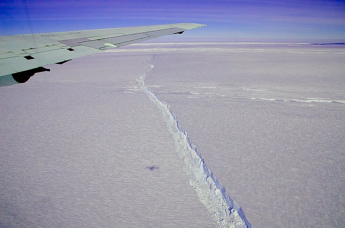 A photo from the window of NASA's DC-8 shows the rift across the Pine Island Glacier ice shelf running off toward the horizon.