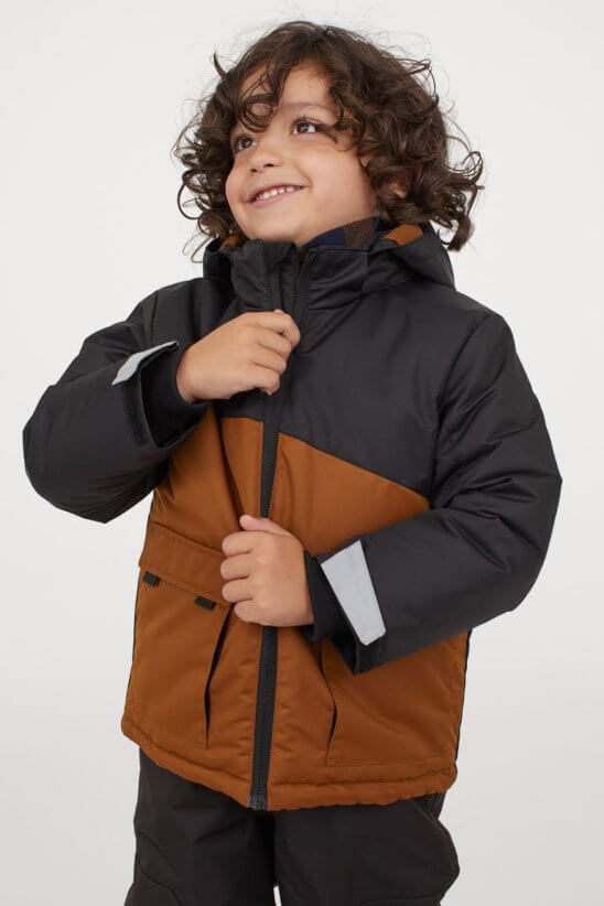 Boy zipping up jacket