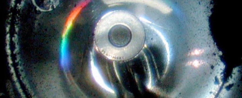 Black asteroid sample residue on the outside of the collection container.